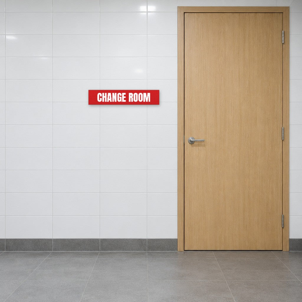 Red and white Change Room sign on the wall beside a change room door in an Australian gym