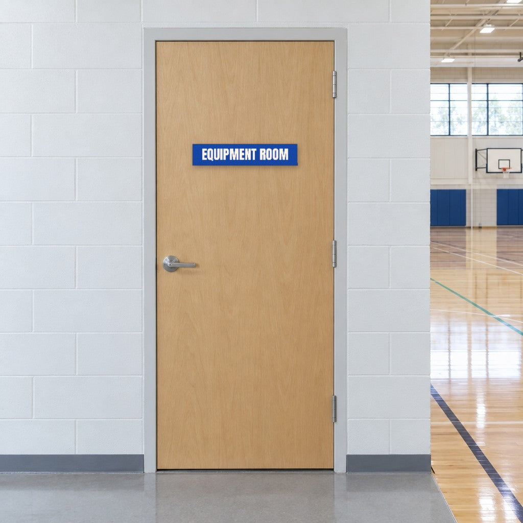 Blue and white Equipment Room sign on an equipment room door beside an Australian school gymnasium