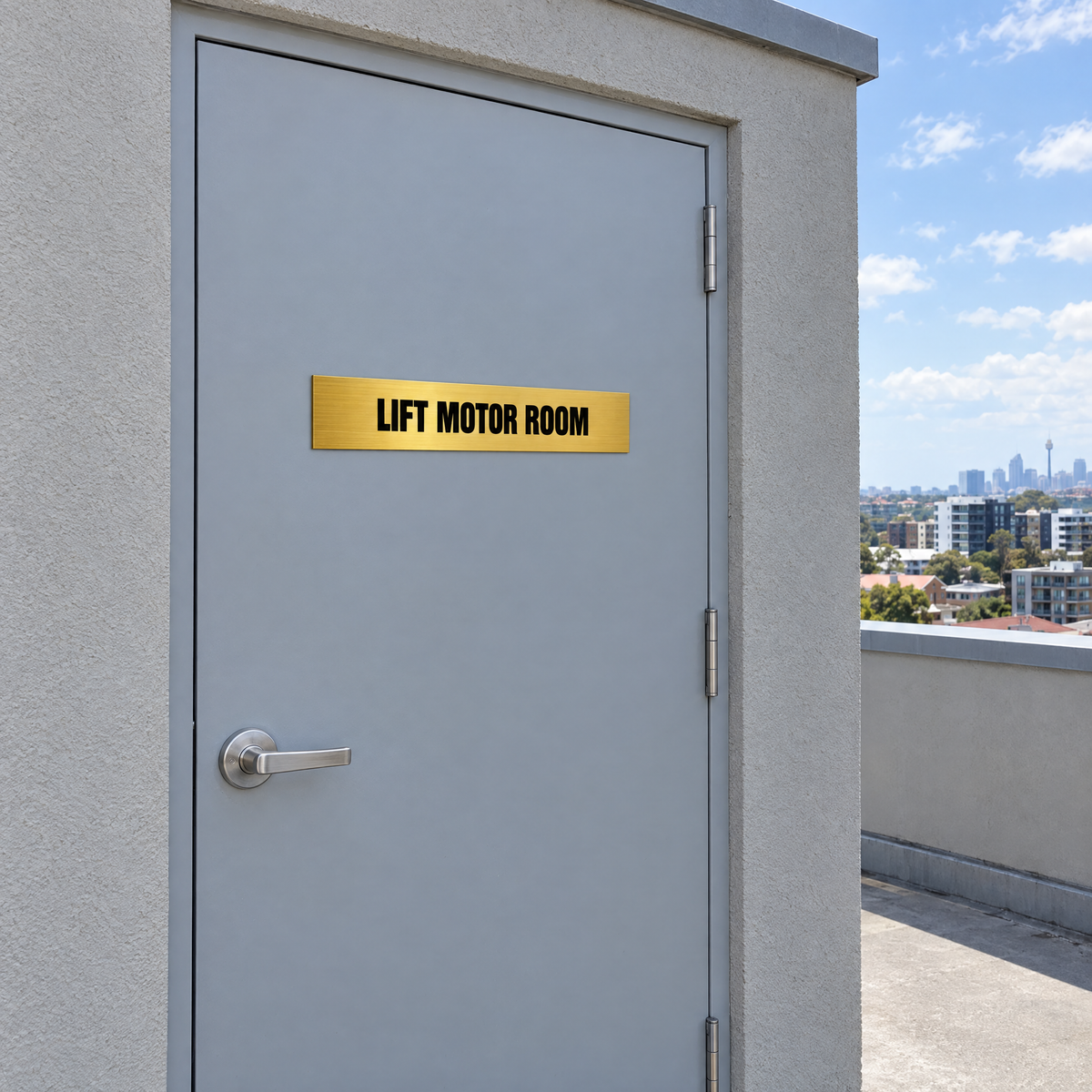 Brushed gold and black Lift Motor Room sign on a lift motor room door on an Australian rooftop