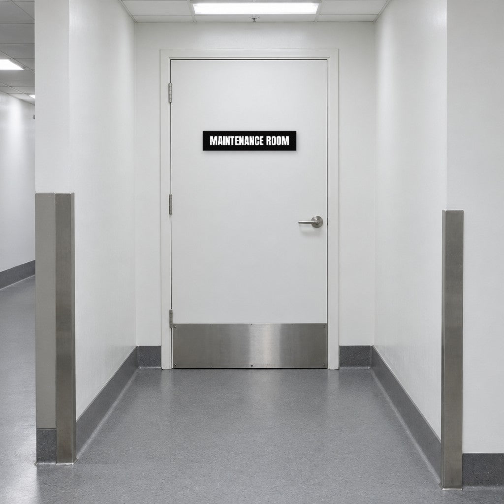 Black and white Maintenance Room sign on a maintenance room door in an Australian hotel back-of-house corridor