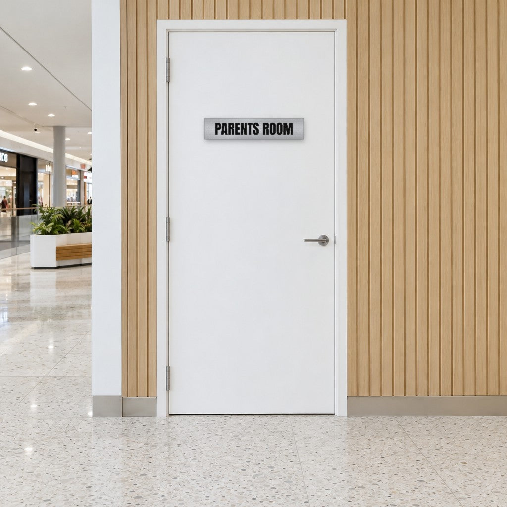 Brushed silver and black Parents Room sign on a parents room door in an Australian shopping centre