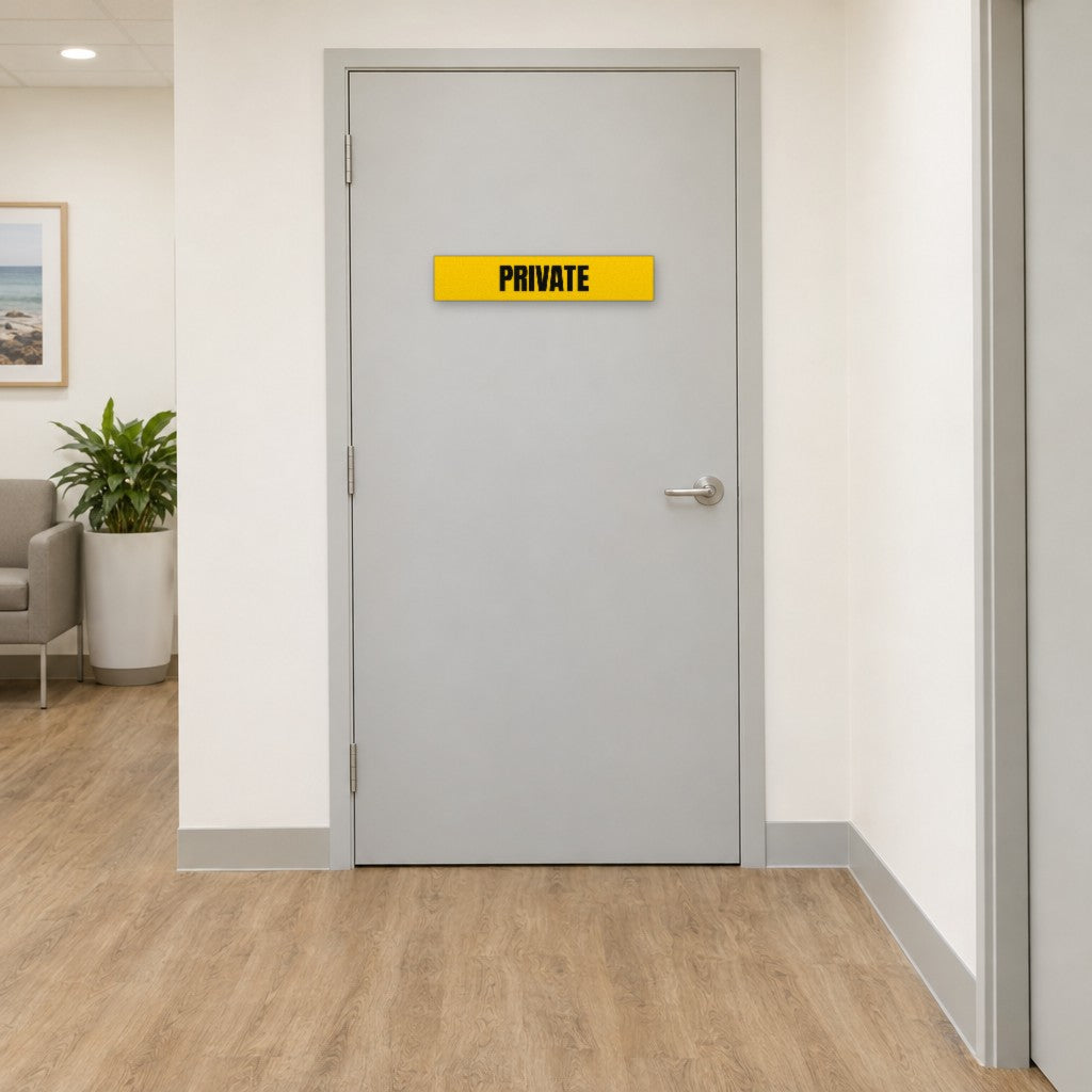 Yellow and black Private sign on a private door in an Australian medical clinic