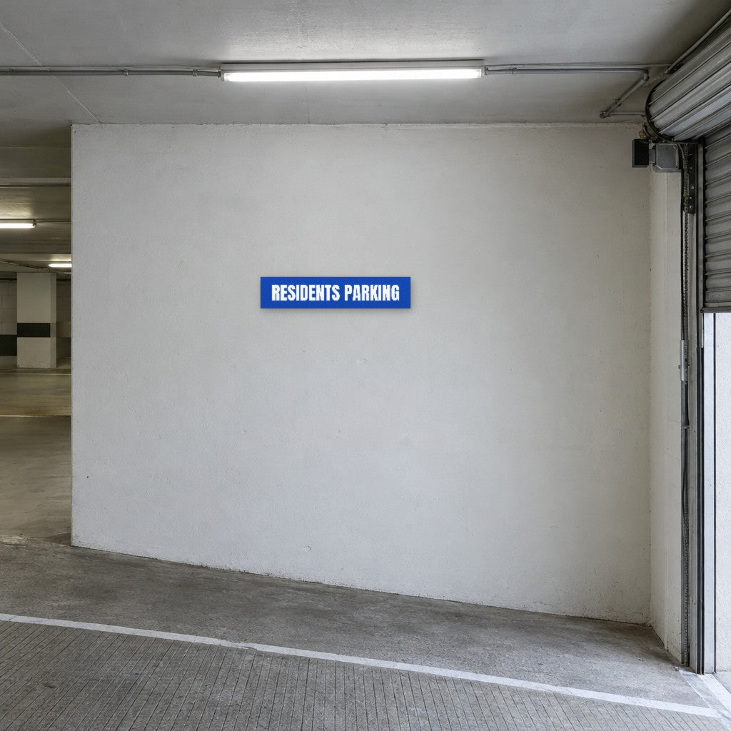 Blue and white Residents Parking sign on the wall at the entry to residents parking in an Australian basement car park