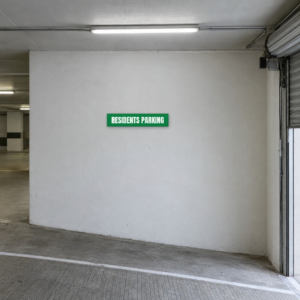 Green and white Residents Parking sign on the wall at the entry to residents parking in an Australian basement car park