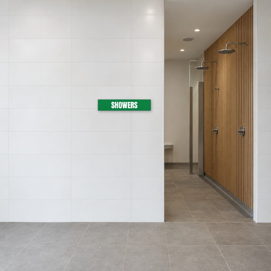 Green and white Showers sign on the tiled wall beside the showers in an Australian end-of-trip facility