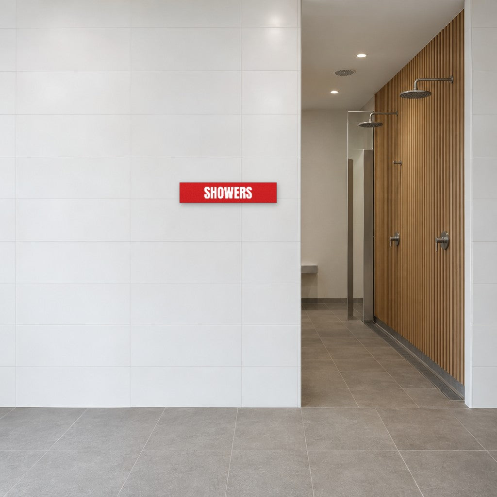 Red and white Showers sign on the tiled wall beside the showers in an Australian end-of-trip facility