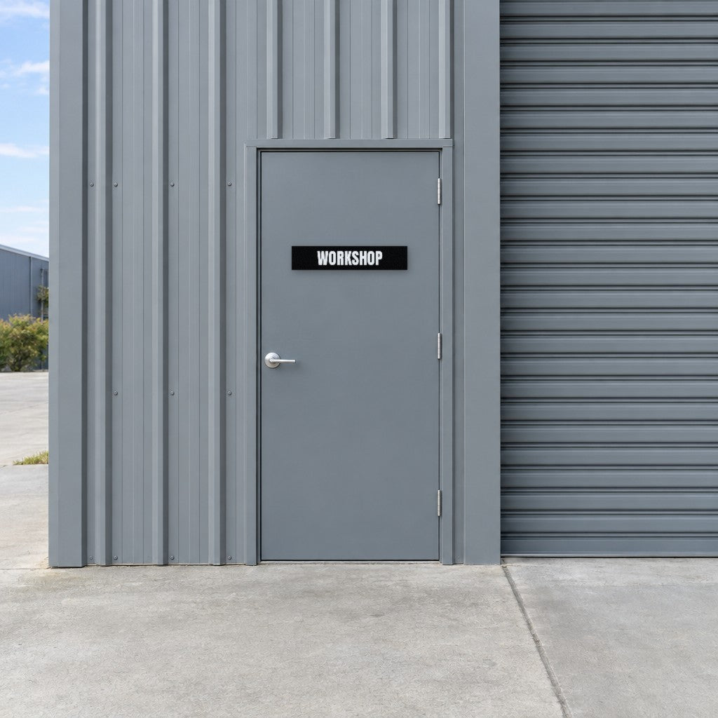 Black and white Workshop sign on a workshop door at an Australian industrial unit